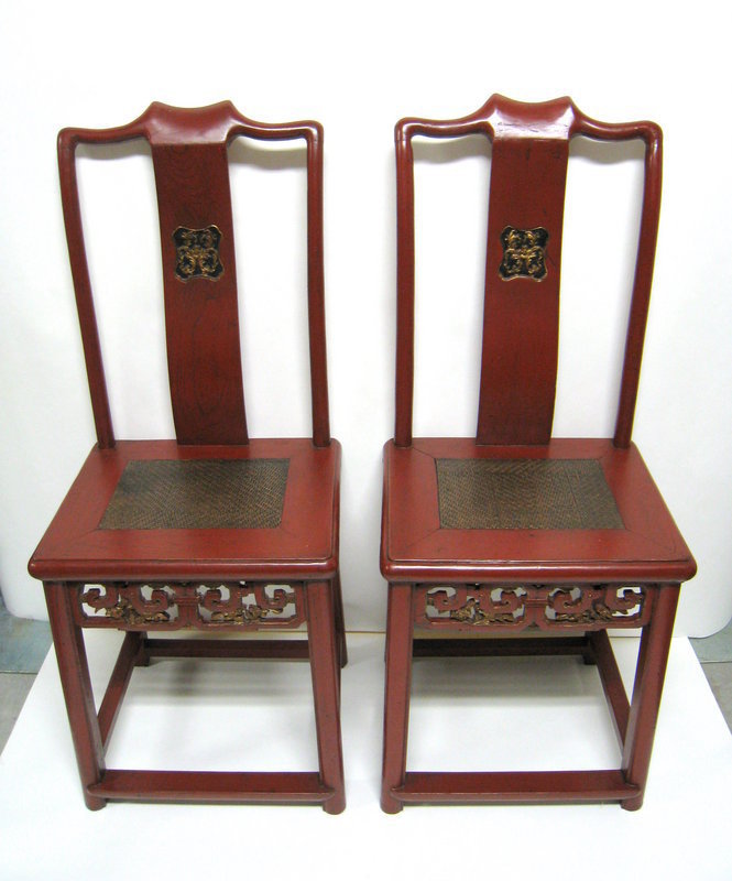 for the pair<br /><br />
DESCRIPTION: A pair of beautiful matching red lacquer Chinese chairs, c. 1880. Crafted from jumu wood (Southern Chinese elm) and originating from Fujian Province, these chairs have matching gilt medallions on the gracefully curved back splats, woven wicker over solid wood seats, and elaborately carved front skirts.  Elegant and attractive.  CONDITION: Excellent, both very sturdy and solid; professional restorations in China to bring them back to their original condition.  DIMENSIONS:  Each chair is 43” high (1.09 m) x 17 ½” wide (44.5 cm) x 15” deep (38 cm).  Seat height is 20 ½” (52 cm). <div id='rater_target1093035'></div>
